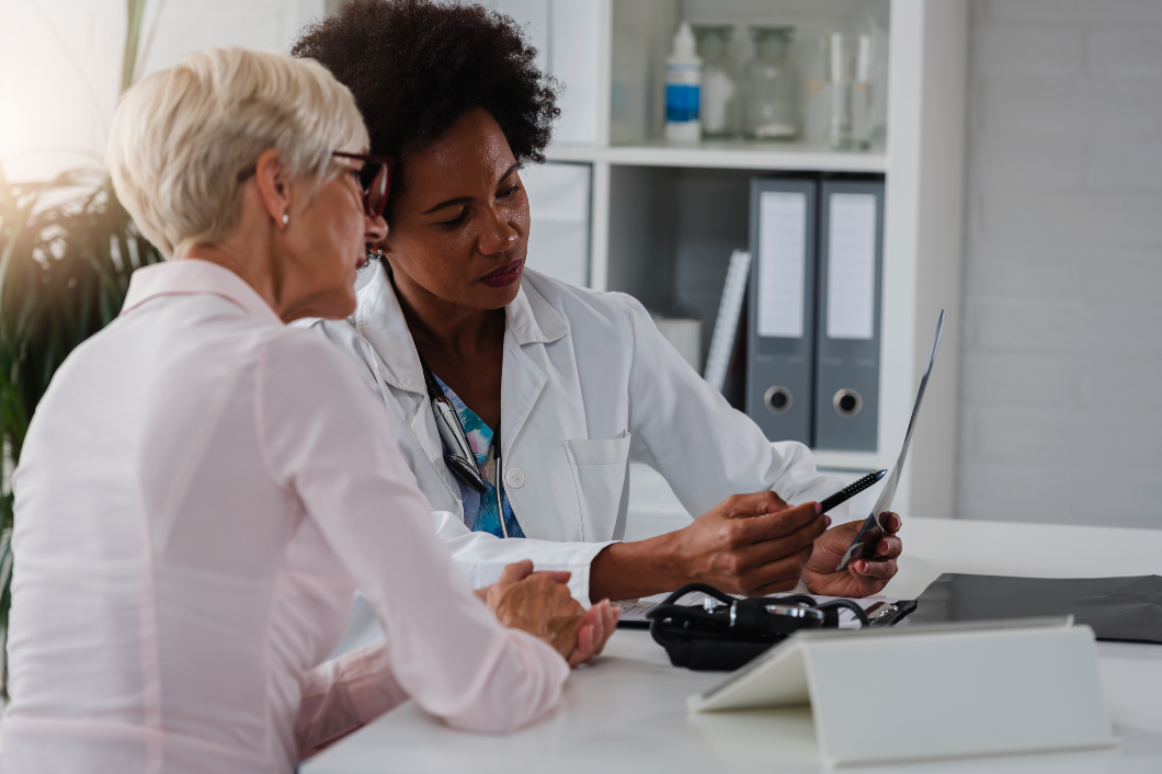 Female doctor explaining something to elderly woman