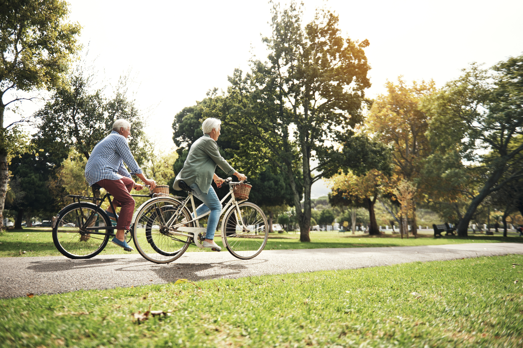 Senior couple biking in nature